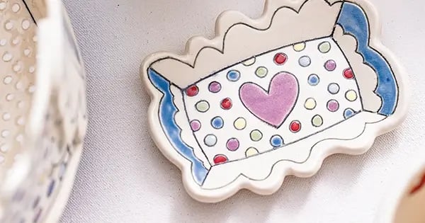 Amy Joy Pottery is known for bright colors, playful symbols and the use of an Italian technique called sgraffito.