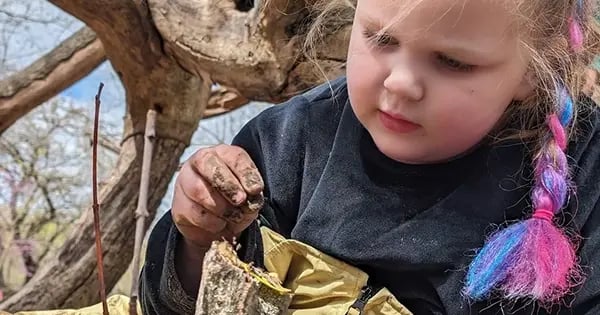 Saint Louis Zoo Second Nature Preschool student explores nature.